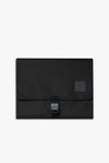 Front view of closed black changing wallet against a white background.