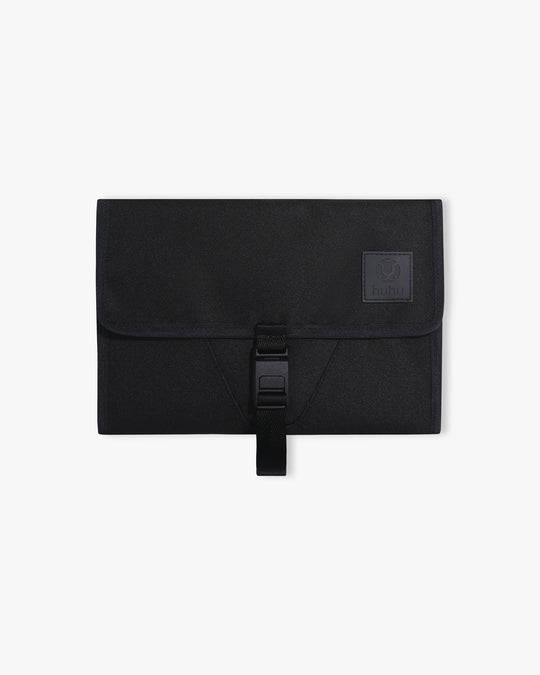 Black changing wallet against white background.