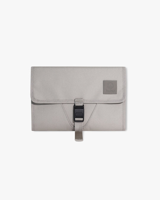 Taupe changing wallet against white background.