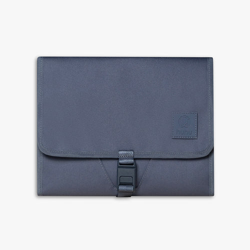 Front view of closed blue changing wallet against a white background.