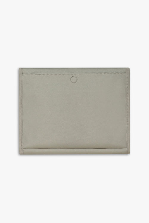Back view of closed taupe changing wallet against a white background showing back, magnetic changing pad pocket.