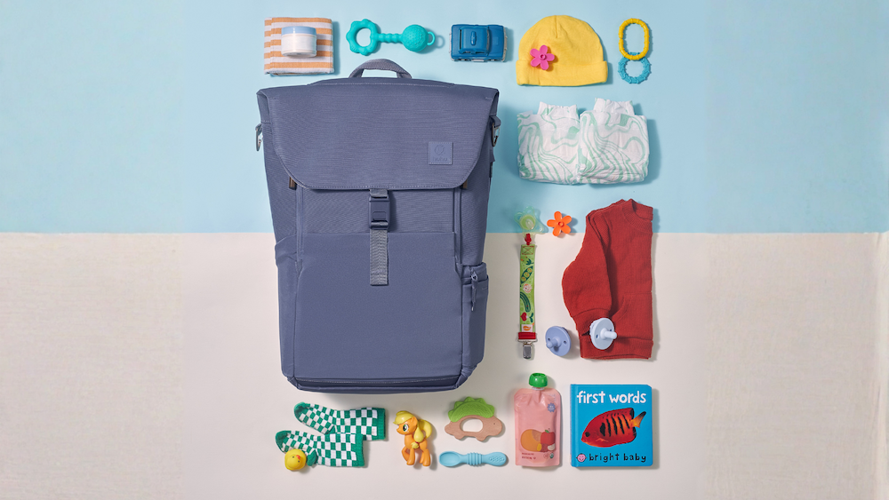 picture of a blue backpack with baby items surrounding it