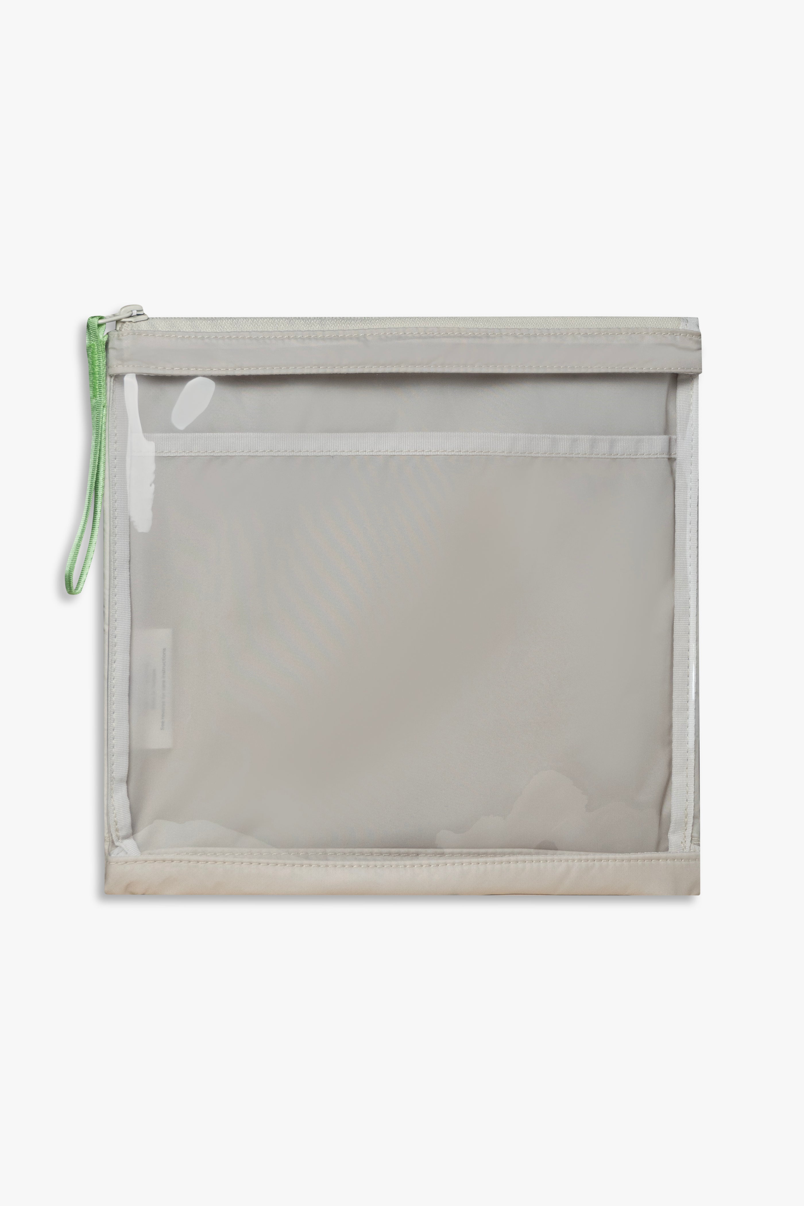 Front view of beige changing wallet with clear front and green zipper pull.
