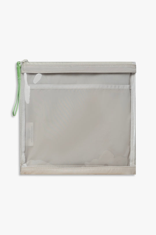 Front view of beige changing wallet with clear front and green zipper pull.