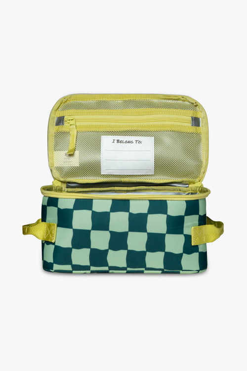Front view of open green checkered insulated cooler bag to reveal yellow mesh zippered pocket and white "I belong to" tag against a white background.