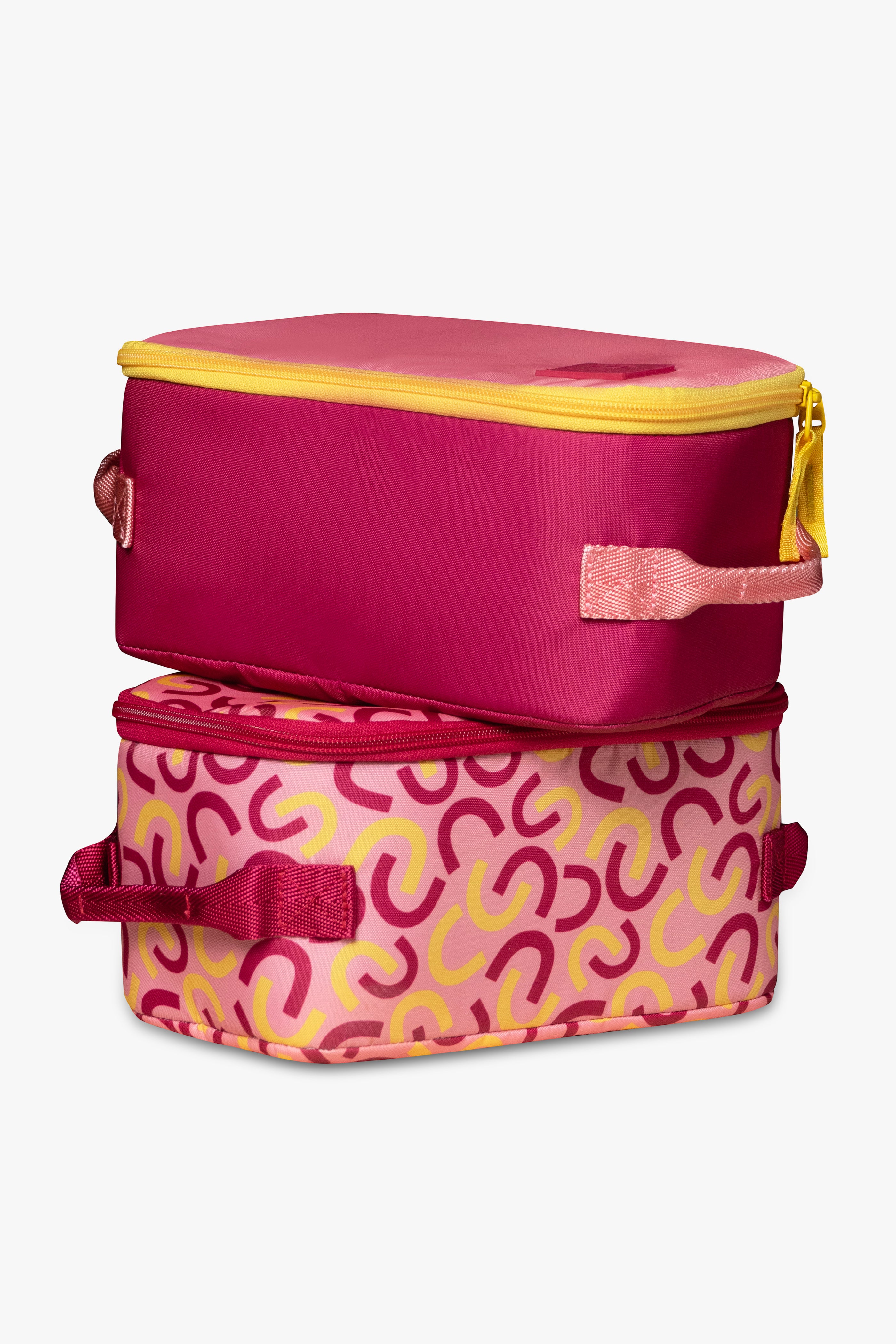 Solid pink insulated cooler bag with yellow zipper sitting on top of pink and yellow macaroni patterned insulated cooler bag with pink zipper against a white background.