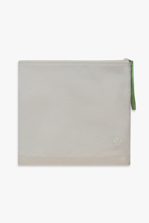 Back view of beige changing wallet with green zipper pull.