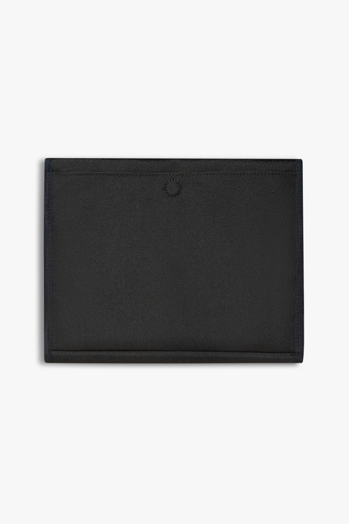 Back view of closed black changing wallet against a white background showing back, magnetic changing pad pocket.