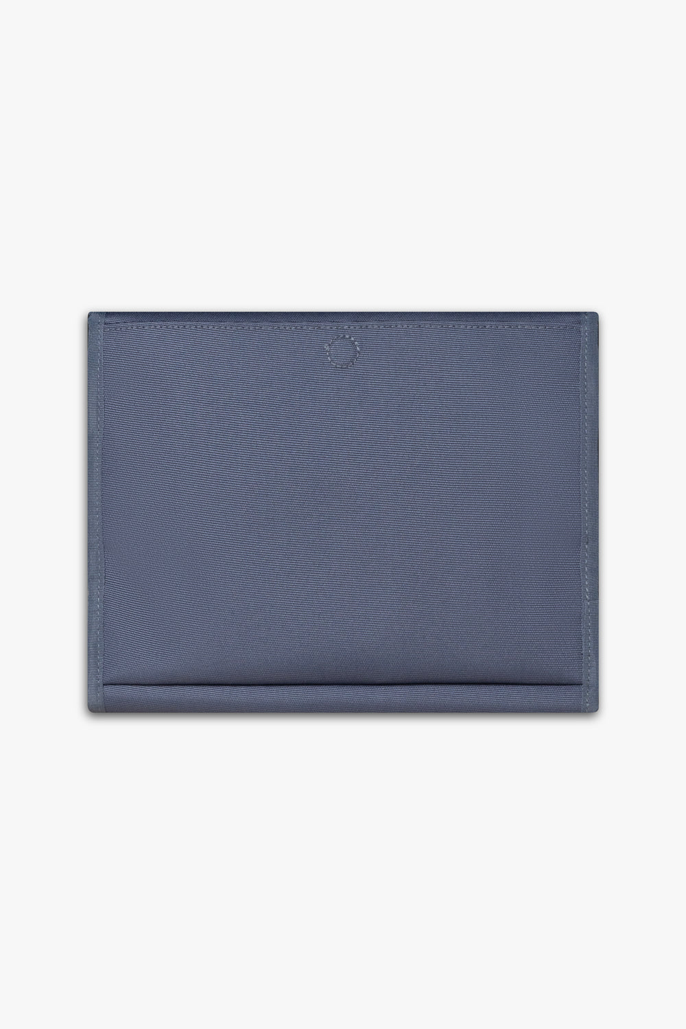 Back view of closed blue changing wallet against a white background showing back, magnetic changing pad pocket.