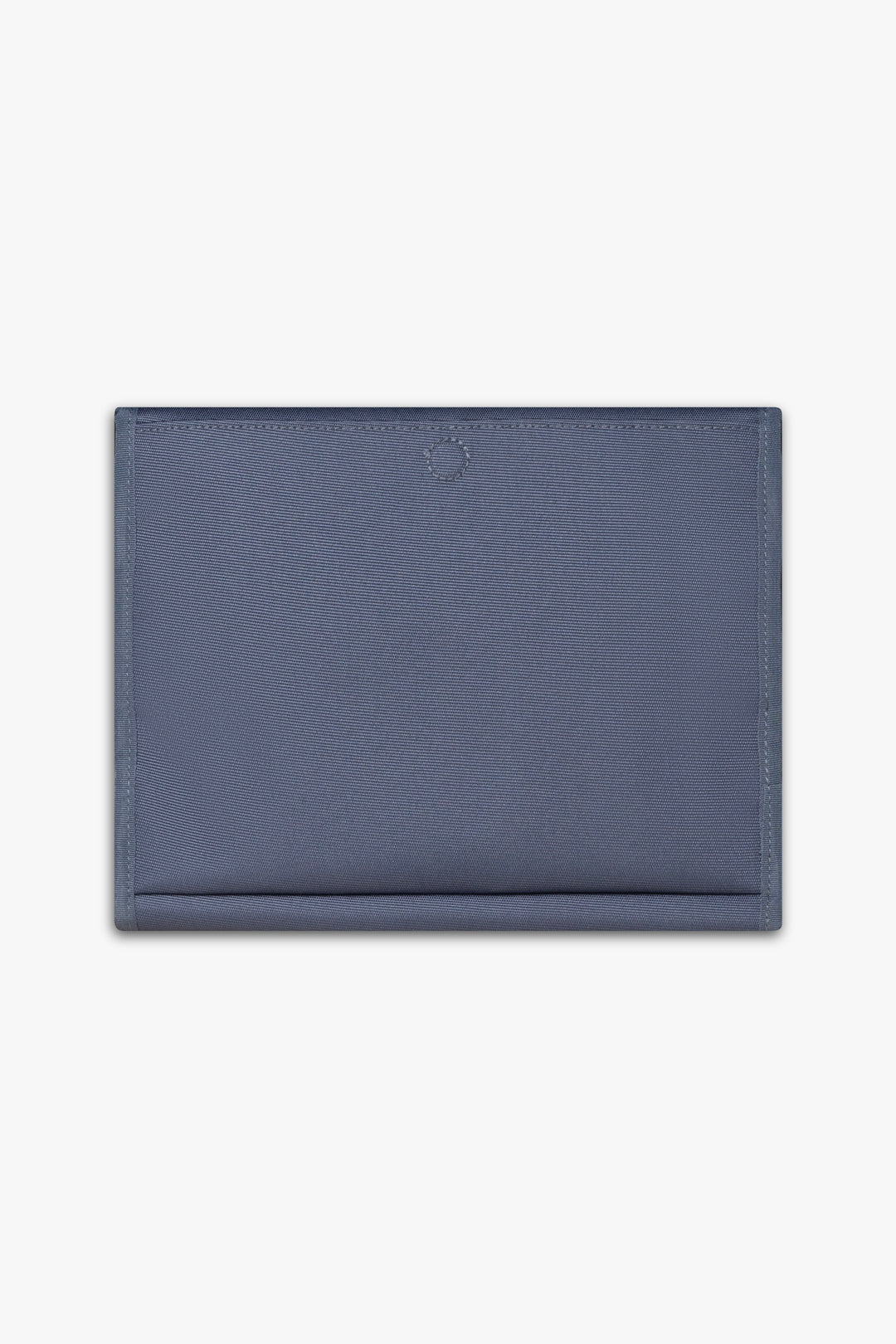 Back view of closed blue changing wallet against a white background showing back, magnetic changing pad pocket.