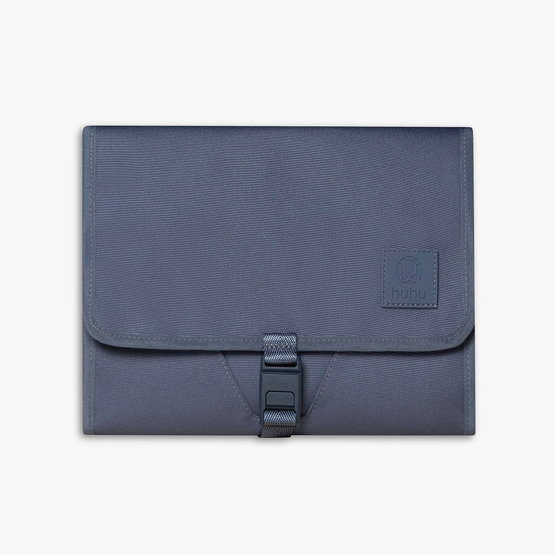 Front view of closed blue changing wallet against a white background.