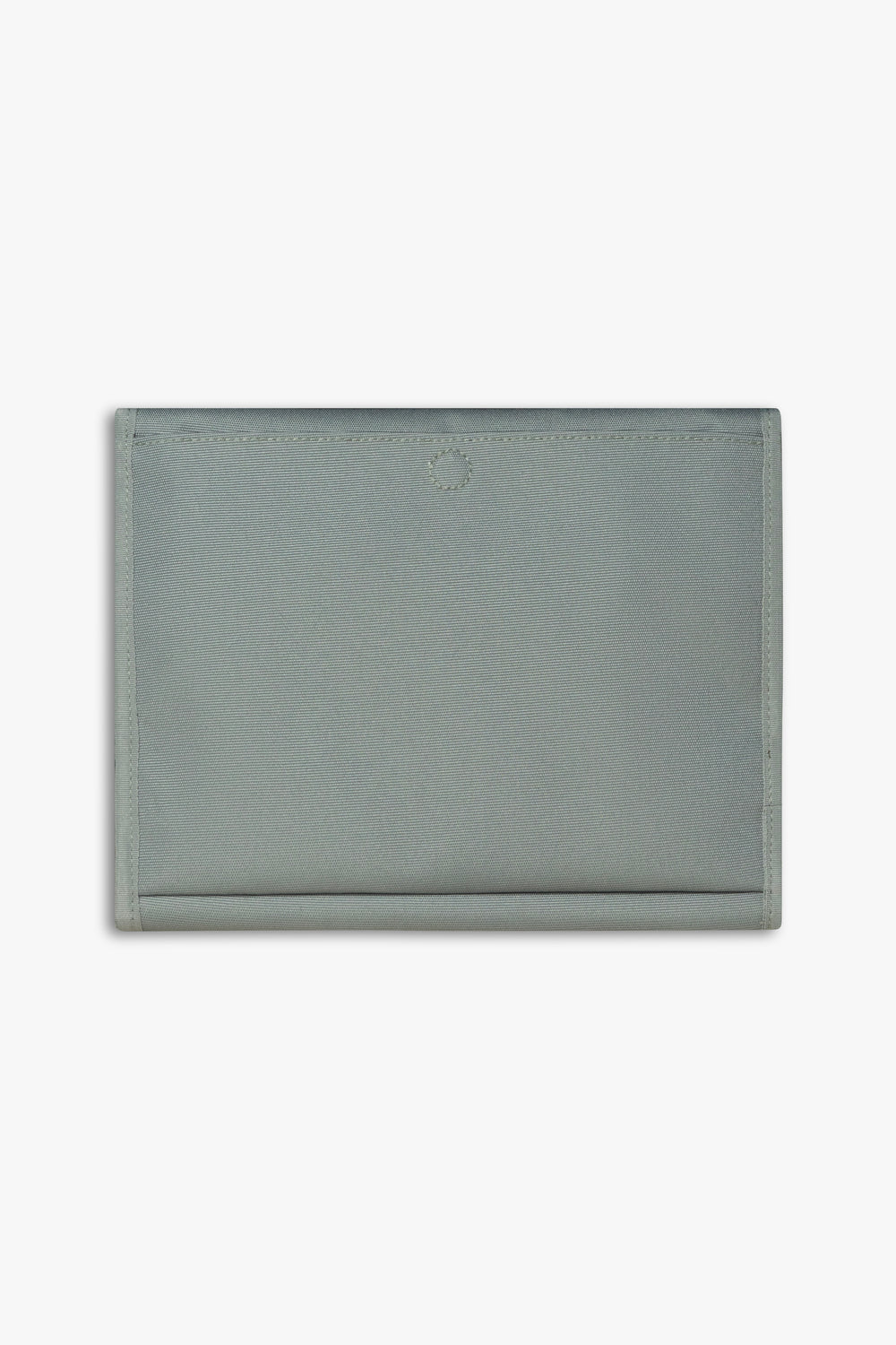 Back view of closed green changing wallet against a white background showing back, magnetic changing pad pocket.
