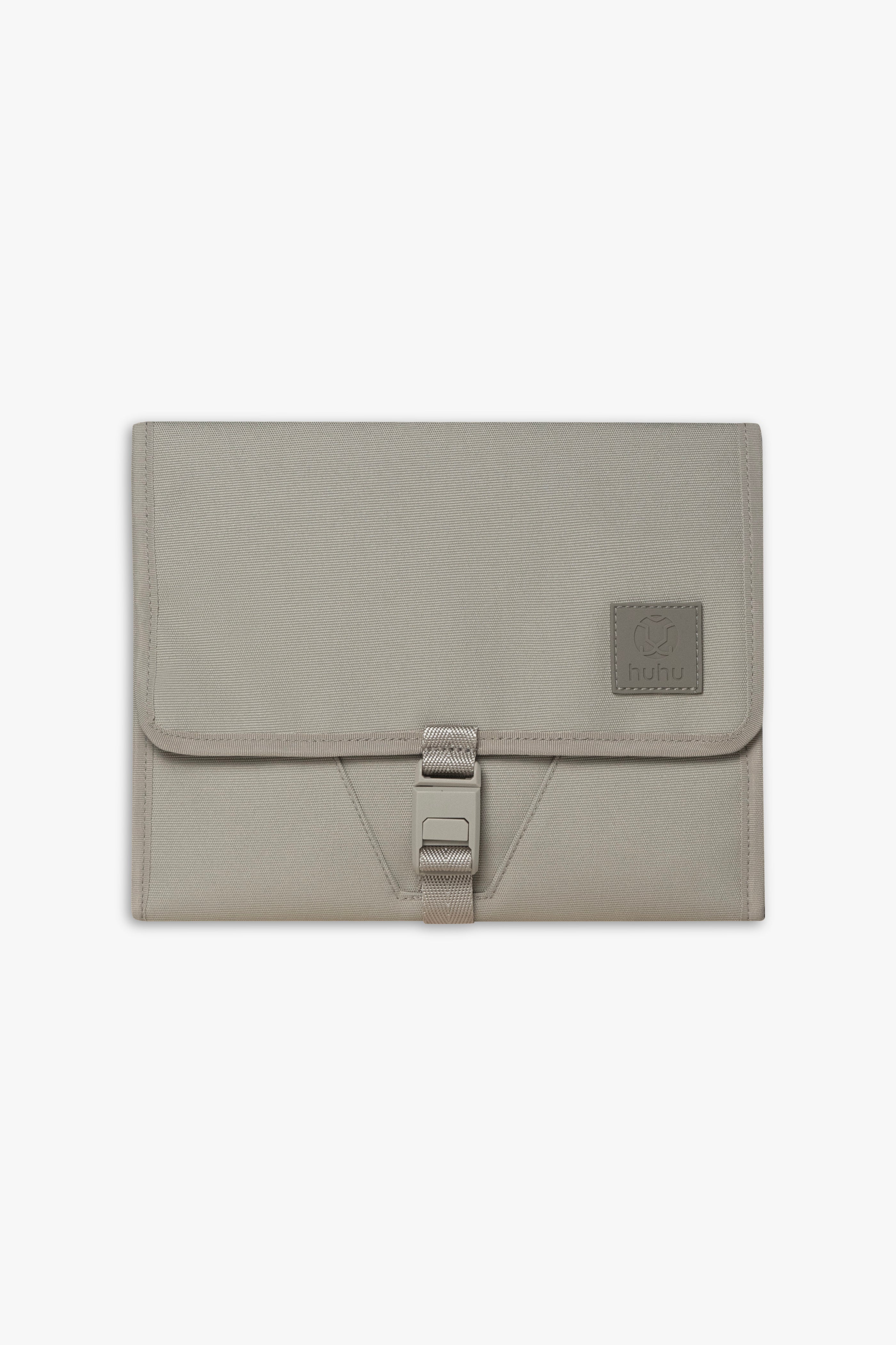 Front view of closed taupe changing wallet against a white background.